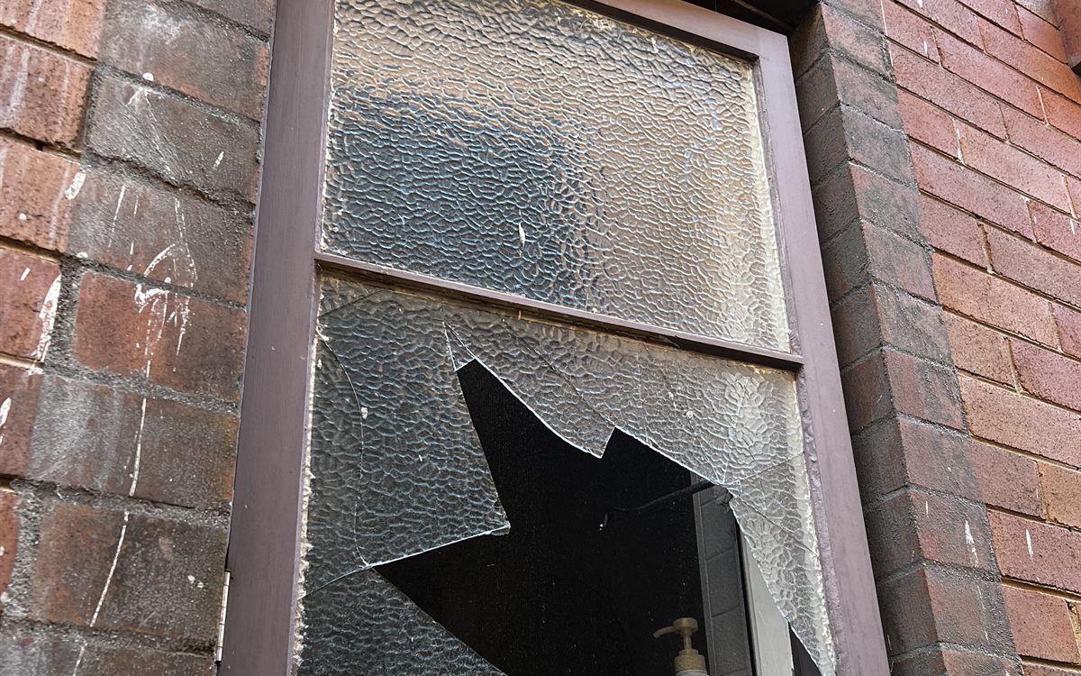 Shattered window glass after a break-in awaiting emergency replacement in Northgate