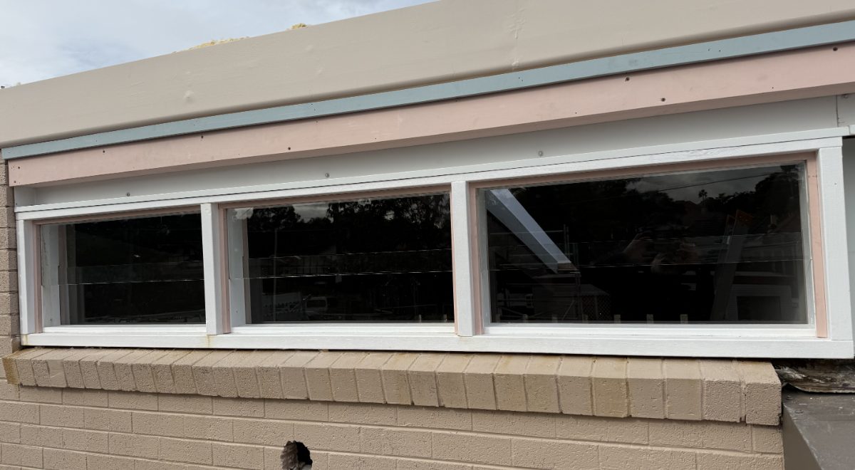 Replacement window glass fitted to a brick building