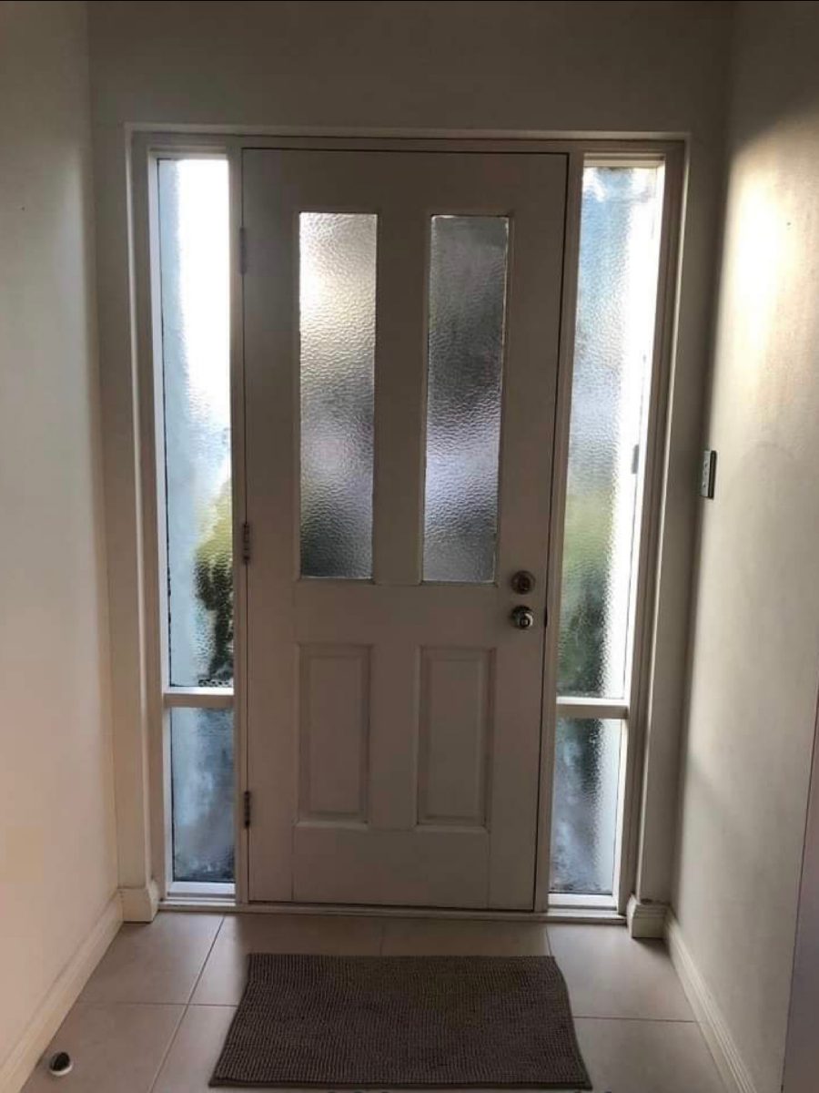 Privacy glass panels in a front entry door near Steiglitz